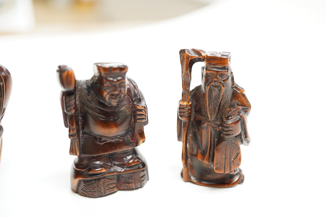 Four Japanese carved wood netsuke to include two elders and a novelty figure seated on a bird, largest 5cm high